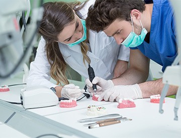 Lab workers creating dentures