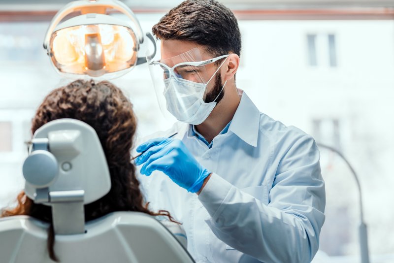 A dentist giving his patient a full mouth restoration